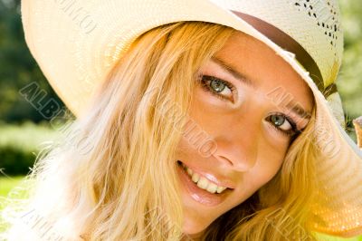 Smiling blond woman in a hat