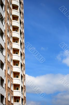 House against a backdrop of blue sky and clouds