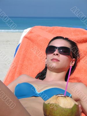 girl on the beach with coconut drink