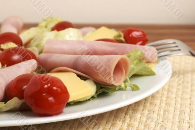 Fresh salad with cold meat, greens and peppers