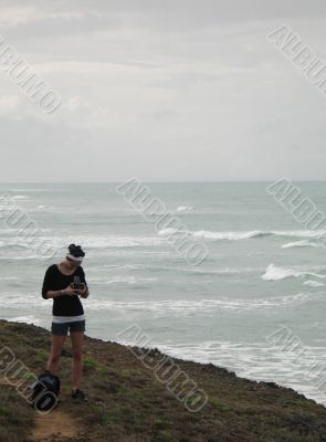girl taking pictures on a cliff