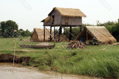 Hut and boat on the river bank