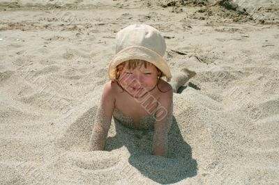 Baby girl plays with a sand
