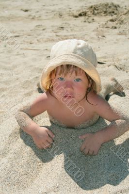 Baby girl plays with a sand
