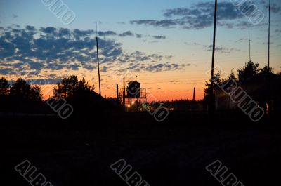 sunset in the orange sky setting over prison yard