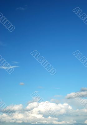 fluffy cloud on bright blue sky