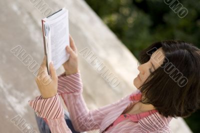 female reading in park