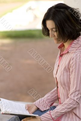 female reading in park