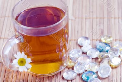 Cup of herbal tea with pebbles