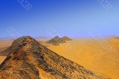 mountains and yellow sand in desert in mist