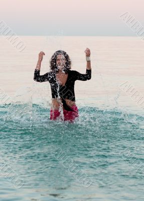 woman in wet clothes splashing