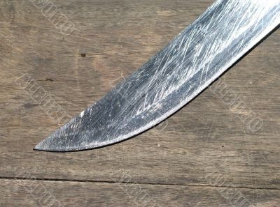 silver knife blade on wood