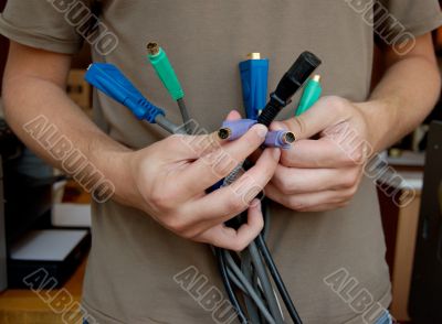 IT specialist holds in his hands the cables