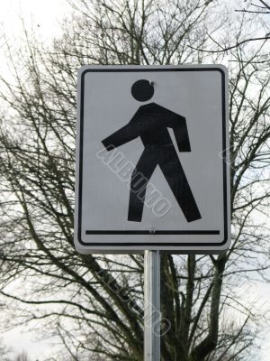 black and white pedestrian crossing sign