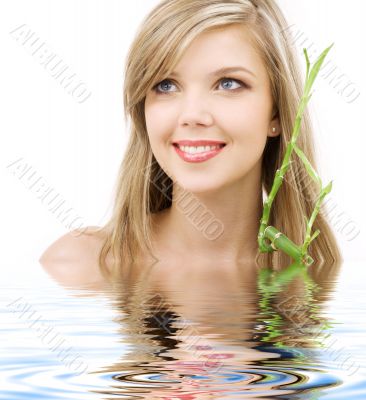 blue-eyed blonde with bamboo in water