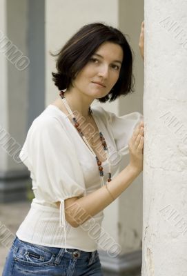 pretty woman standing near white column