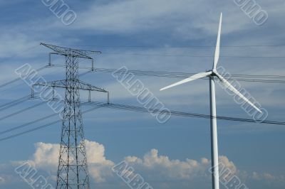 a windturbine close to a electric pylon
