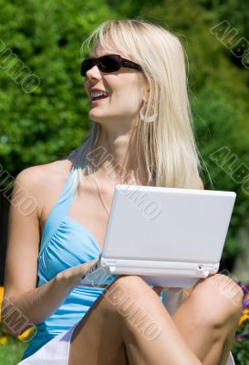 outdoor picture of lovely blonde with laptop