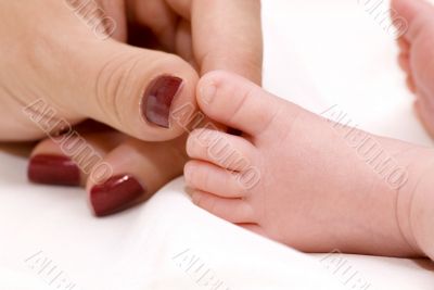 Mother`s hand and baby`s foot