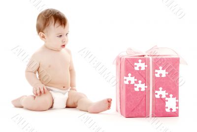 baby boy in diaper with big puzzle gift box baby boy in diaper with big puzzle gift box
