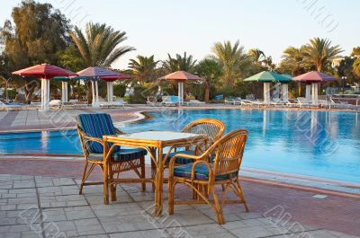 Three arm-chair near swimming pool.