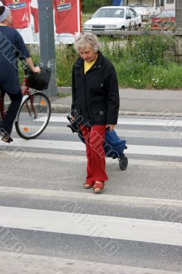 Old woman crossings a road Old woman crossings a road