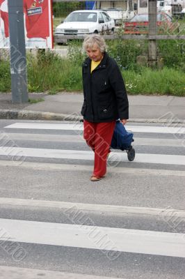 Old woman crossings a road Old woman crossings a road