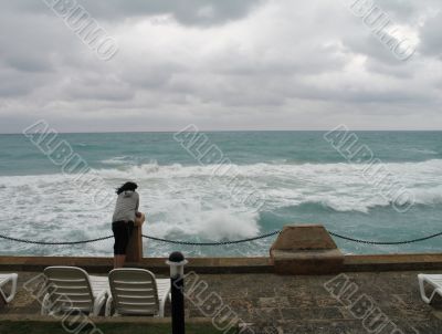 man watching the stormy ocean
