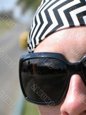 girl wearing a bandana and sunglasses
