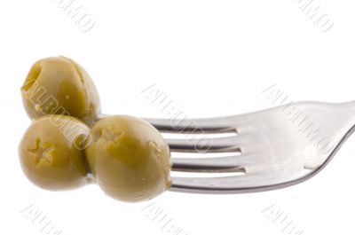 Green olive on fork
