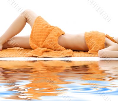 torso of relaxed lady with orange towels