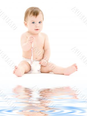 baby boy in diaper with toothbrush