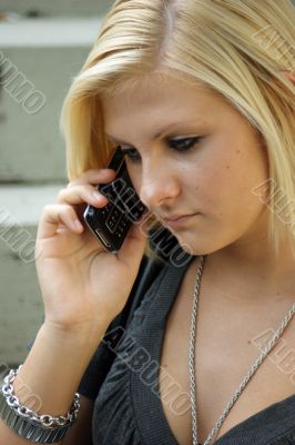 Young, blonde girl with a mobile phone.