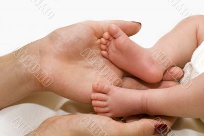 Mother`s hand and baby`s foot