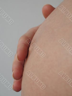 hand on a pregnant belly hand on a pregnant belly