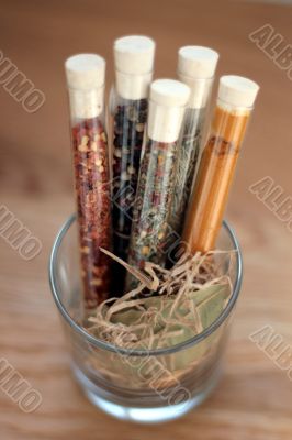 spices in a glass on wood table