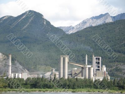 large factory at the foot of the mountains