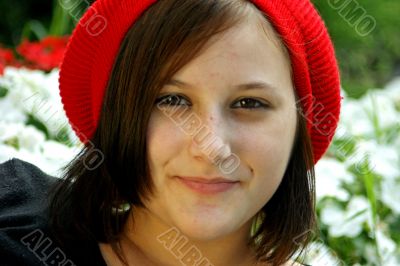 Portrait of a young girl with red cap.