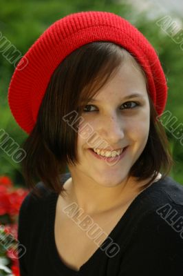 Portrait of a young girl with red cap.