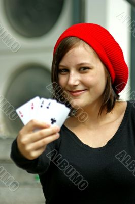 Girls with red cap holds four playing cards
