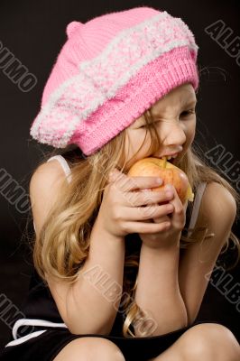 little girl biting apple