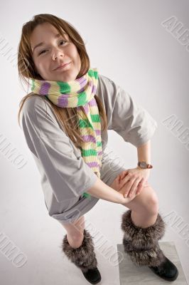 young happy woman in striped muffler