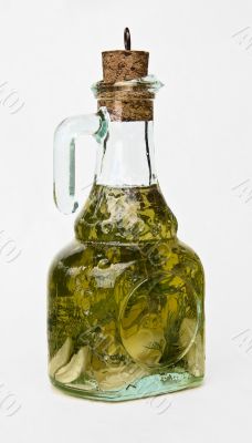 Bottle of olive oil with spice green herbs