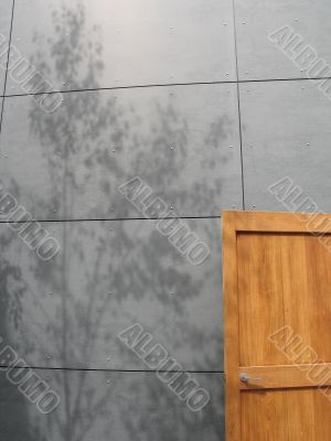 grey concrete wall and wooden door