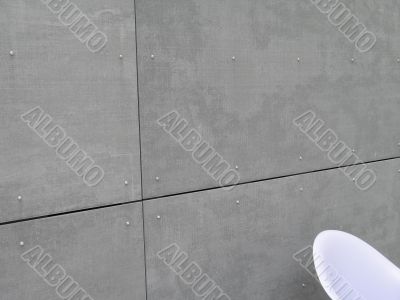grey concrete wall and white chair