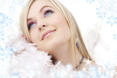 happy blond angel girl with feather boa