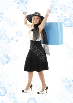 blond in retro hat with blue shopping bag