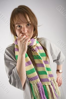 thoughtful young woman in striped muffler
