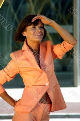 Young business woman in a cream colored dress.