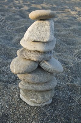 ten stones cairn on the beach